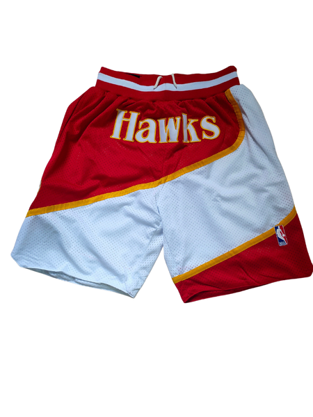 Retro NBA basketball shorts with bold team logos and vintage design, featuring elastic waistbands and detailed stitching